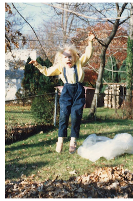 Girl jumping in leaves