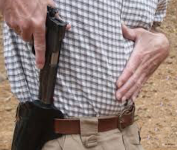 Person drawing gun with shooting hand, keeping nongrip hand pressed against upper body